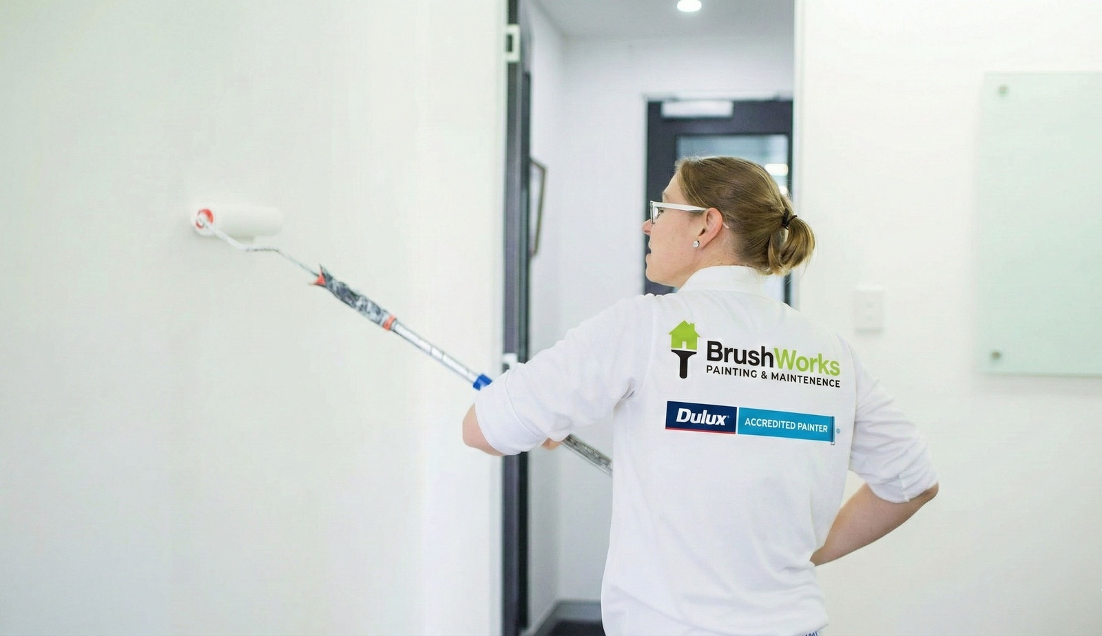Brushworks painter working on an exterior wall