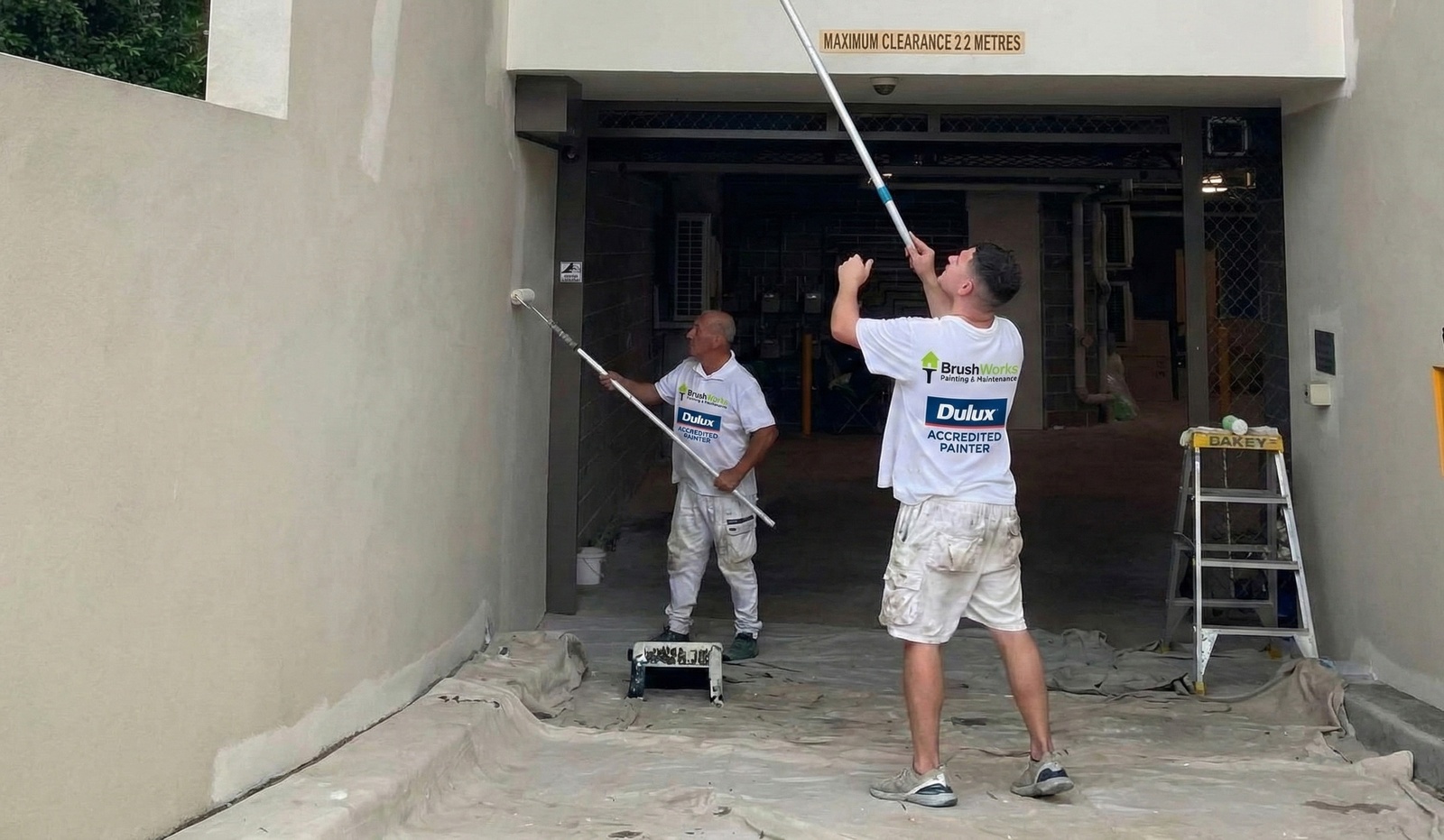 Brushworks painters preparing driveway surface for coating