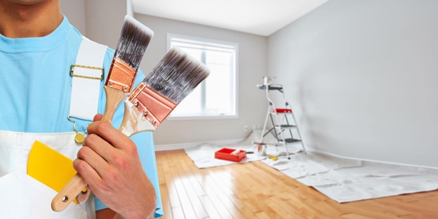 Painter holding brush while doing a residential painting work in Sydney
